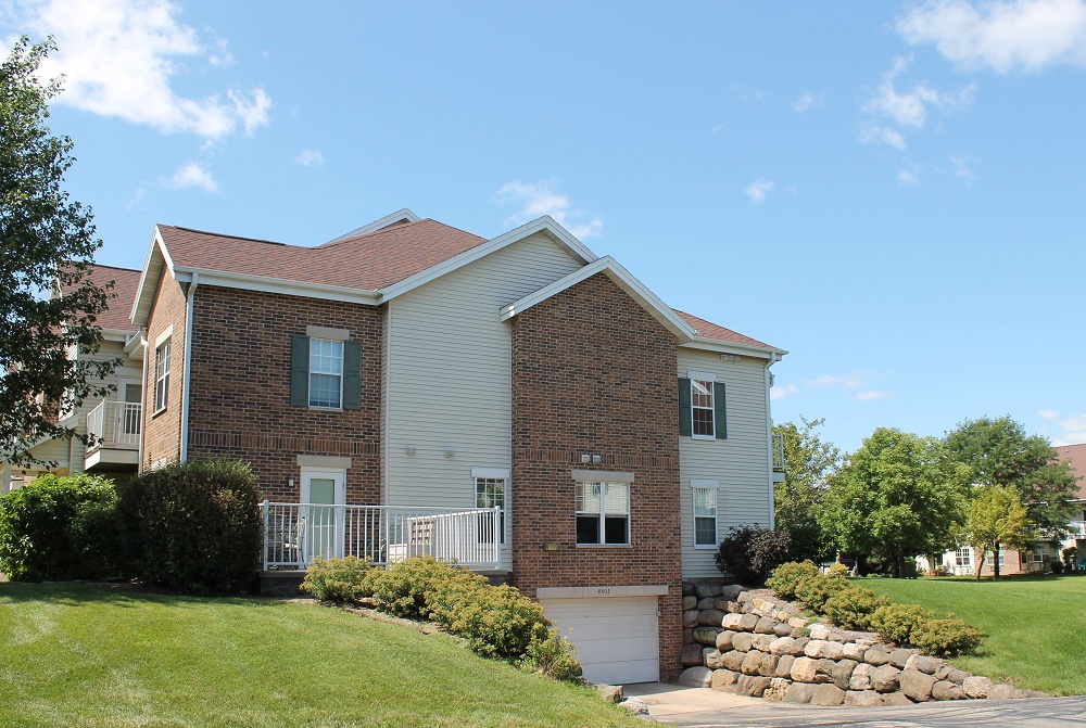 Side of apartment building showing the garage door below