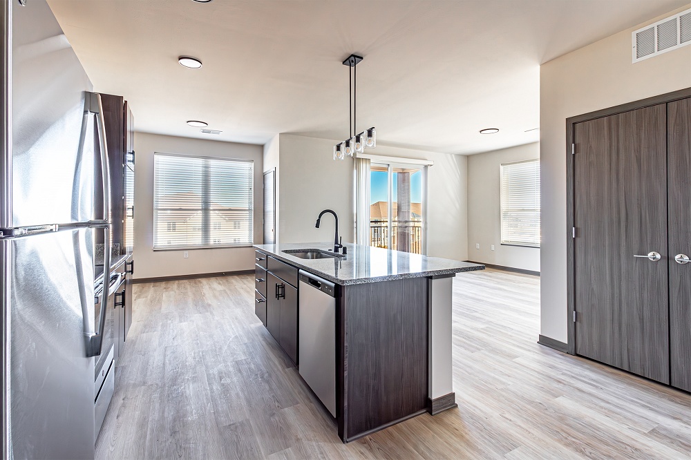 An empty apartment kitchen with an island