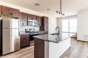 An empty apartment kitchen with an island