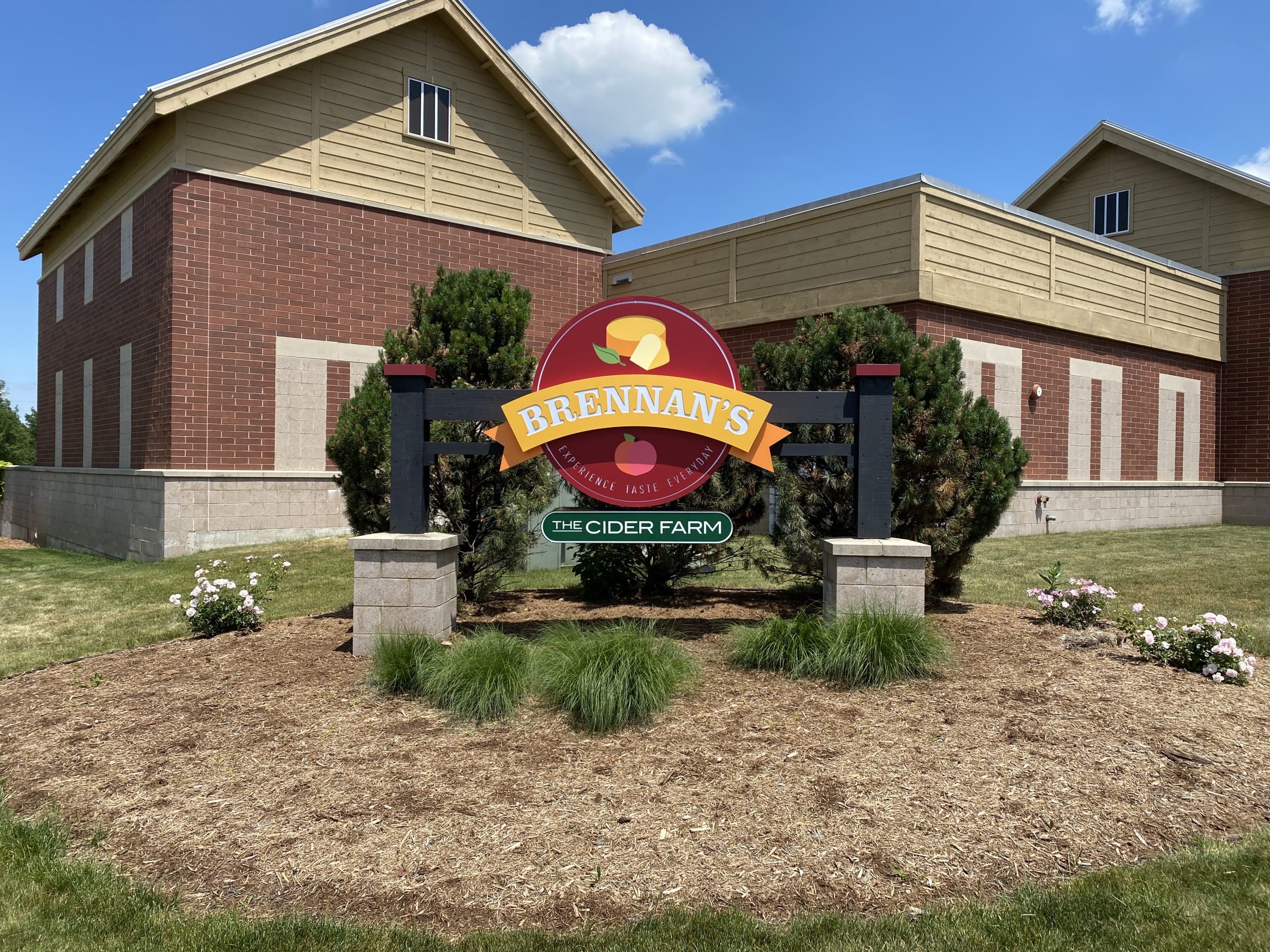 Sign in front of commercial space for Brennan's Market and The Cider Farm