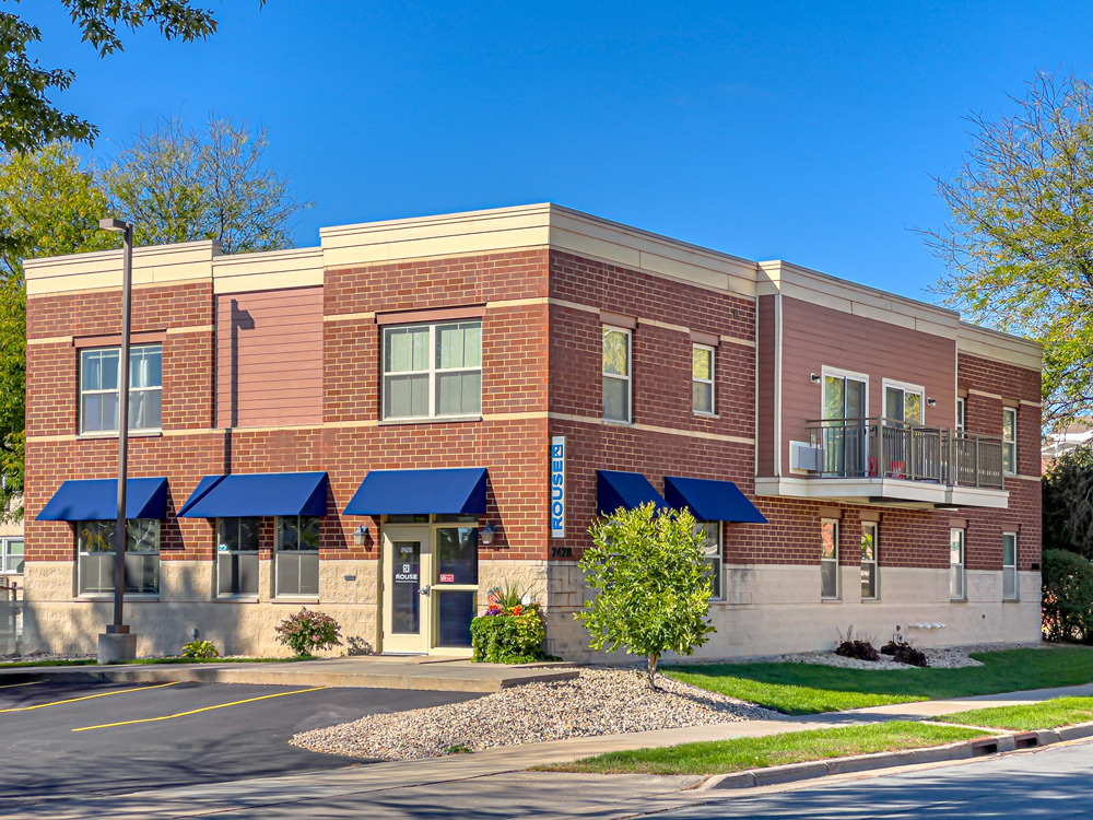 A corner view of a two story brick building, the Rouse offices