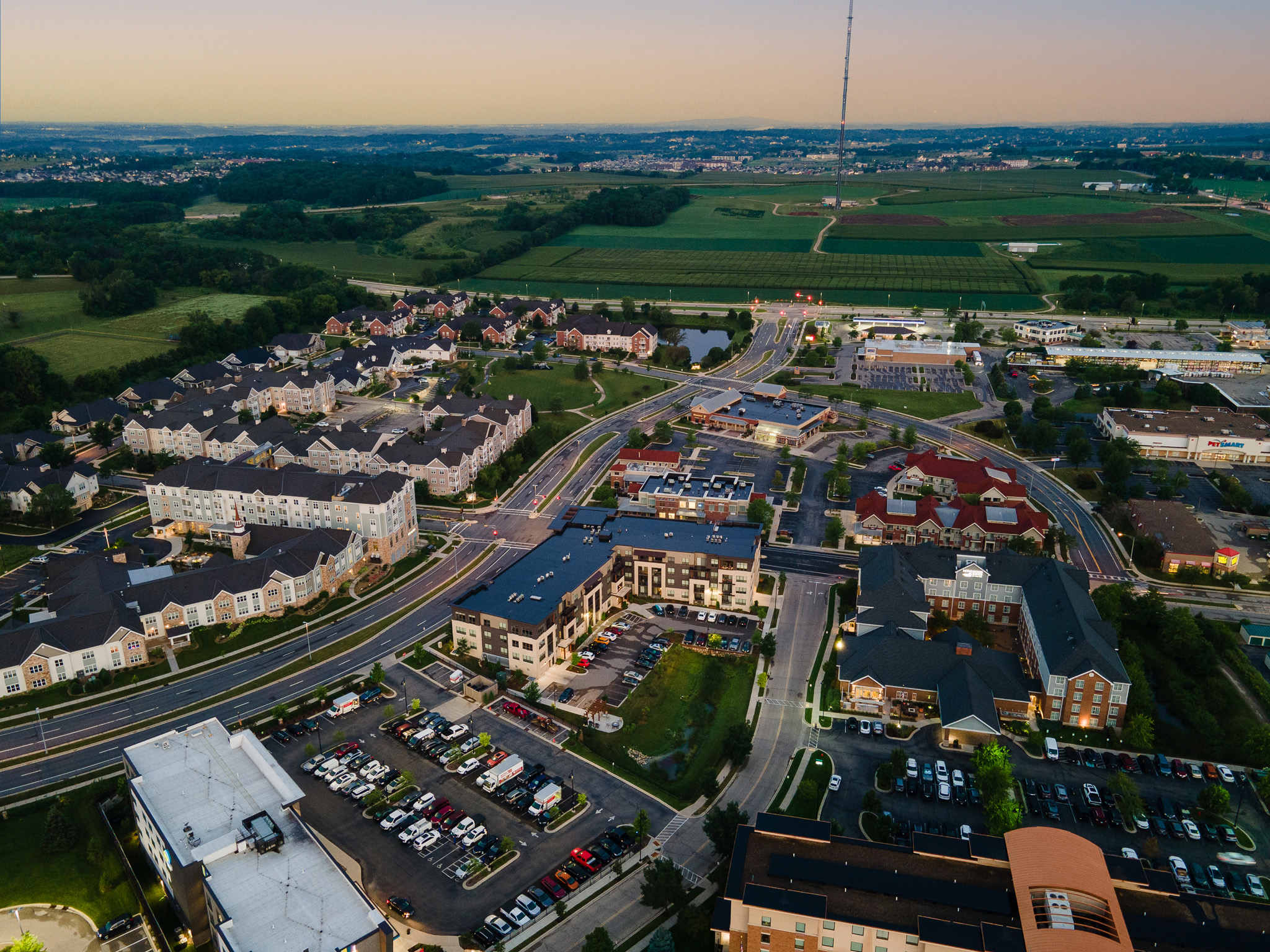 Aerial shot of apartment complexes and farm land at dusk