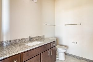 an empty apartment bathroom with a toilet and sink